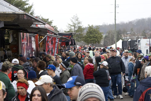 fans lining up at the race merchandise trailers